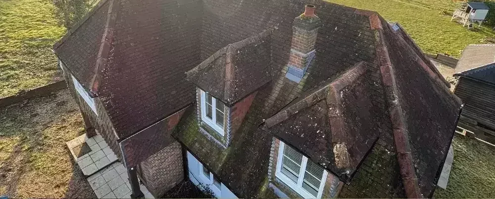 Drone image showing a moss-covered roof before treatment by Neptune Window Cleaning’s roof cleaning service.