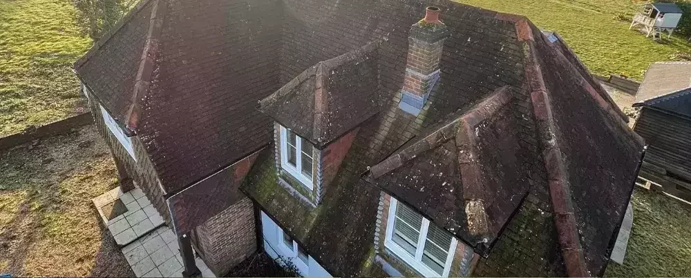 Drone image showing a moss-covered roof before treatment by Neptune Window Cleaning’s roof cleaning service.