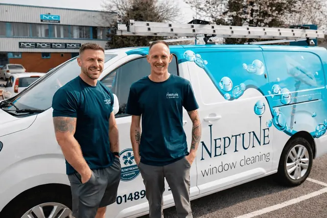 Two Neptune Window Cleaning team members beside a Neptune van